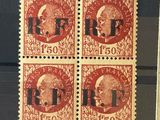a close up of four stamps on a black surface