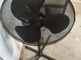 a small table with a fan on it in a store