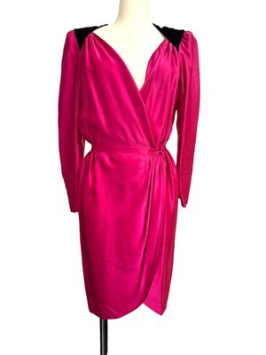 the dress is pink and has black trims on the shoulders