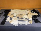 a table with a lot of laces and other items on it