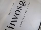 a white bag with black writing on it sitting on a table