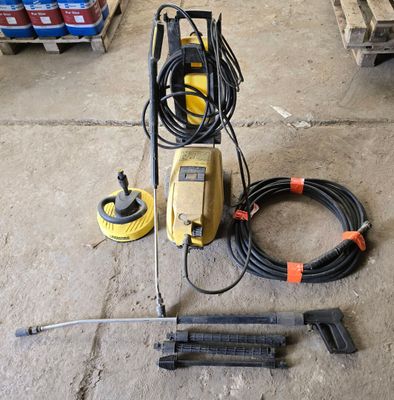 an image of a power washer and hoses in a garage
