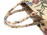 the small bag is decorated with a floral pattern and has a zipper closure