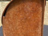a brown bag sitting on a table with a handle