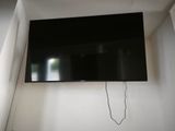 a flat screen tv mounted on the wall in the corner of a room