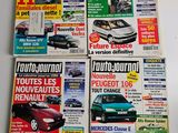 four magazine covers of different cars on display on a table
