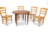 four chairs around a table with a wooden table top