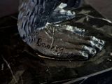 a statue of a bird that is on top of a book