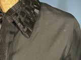 an image of a mannequin wearing a black shirt and tie