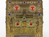an image of a gold box with colorful stones on it