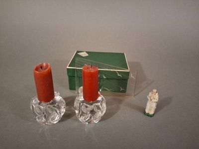 two candles that are sitting next to a box