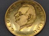 a gold coin with a picture of a man on it