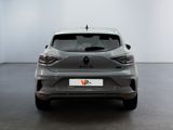 the rear end of a grey car in a white room