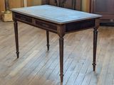 a wooden table with a marble top on a hard wood floor