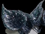 a close up of a piece of metal with a black background