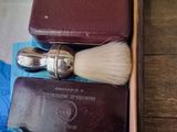 a wooden box with a razor and other items in it