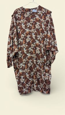 an image of a brown and white floral shirt hanging on a hanger