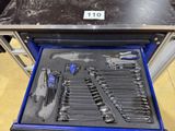 many tools in a tool box on the floor