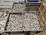 boxes of screws and nuts are stacked on top of each other