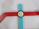 a close up of a red and blue cross on a white surface