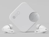 an image of a pair of ear buds sitting on top of a white box