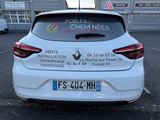the back of a white car parked in a parking lot