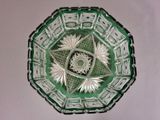 a green glass bowl with a star design on it