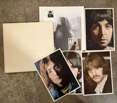 a lot of pictures of the beatles on the floor