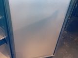 a small refrigerator in the middle of a kitchen
