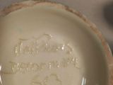 a white plate with a writing on it sitting on a table