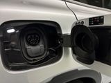 an electric car plugged in to an electric vehicle at a charging station