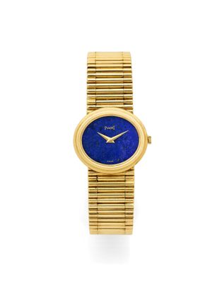 a gold and lapis watch with a blue dial