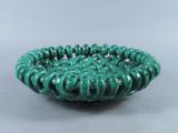a close up of a green bowl on a table