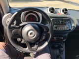 dashboard of a small car with a person sitting in the driver ' s seat