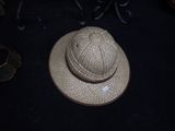 a hat that is sitting on a table next to a pair of scissors