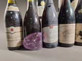 several bottles of wine are lined up in a row on a table