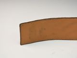a close up of a leather belt on a white surface