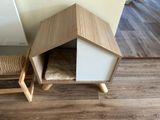 a small dog house with a cat bed in it