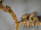 a gold colored table with a bird on it