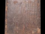 an old wooden board sitting on top of a wooden table