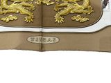 a close up of a brown and white bag with a gold dragon on it