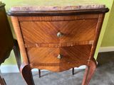 a small wooden table with a marble top on it