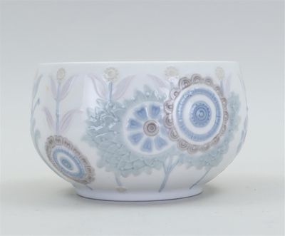 a white bowl with blue and brown designs on it