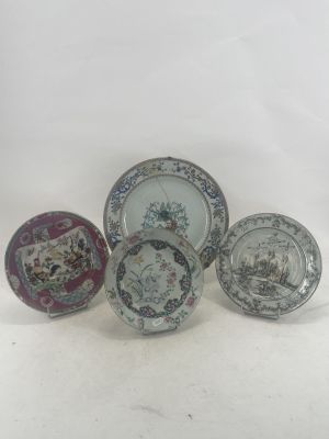 five plates with different designs on them sitting on a white surface