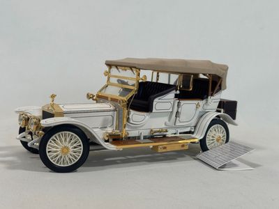 a model of a white car with a brown roof