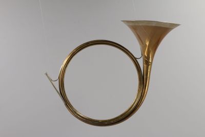 a brass instrument hanging from the ceiling in the room