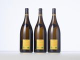 three bottles of wine sitting on top of a table next to each other