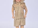a small doll that is standing on a metal stand