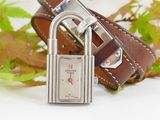 a brown leather belt with a silver padlock on it