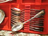 a red tray with spoons and silverware in it